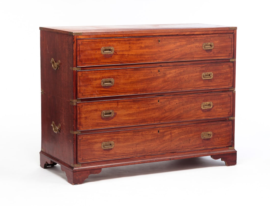 CAMPAIGN DESK IN TWO SECTIONS.: England, second half 19h Century. Mahogany. Both sections have brass bound corners and recessed hardware. Drawers with applied beaded edges, ebony line inlays and bale handles on ends. Top has pull ou