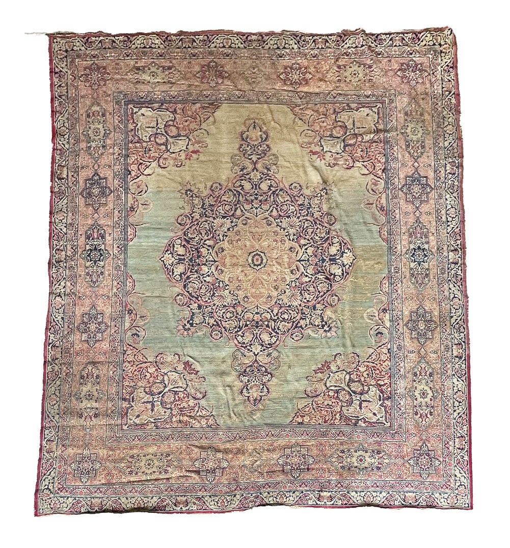 KIRMAN RUG.: First half 20th Century. Room size with wide ivory border and pale green ground. Stains, worn areas. 10'7"w. 12'3"l.