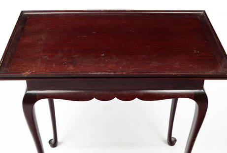 WALLACE NUTTING QUEEN ANNE STYLE TEA TABLE.: American, first quarter 20th Century. Cherry. Tray top, shaped apron, cabriole legs and pad feet. Branded label inside apron. Original finish has wear. 28"h. 30"w. 18.5"d.