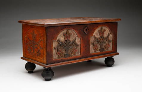 PAINT-DECORATED MINIATURE CHEST.: American, 20th Century. A birch William and Mary style blanket chest with relief carved lid and sides with onion feet. Some wear. 4" h. 11" w. 5.5" d.