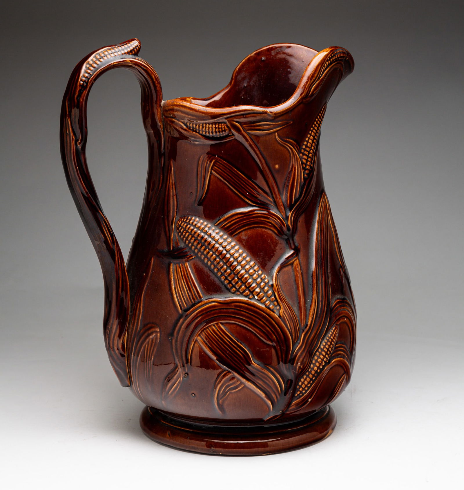 LARGE ROCKINGHAM PITCHER WITH EMBOSSED DECORATION. (1 of 5)
