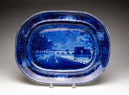 ENGLISH HISTORICAL BLUE STAFFORDSHIRE PLATTER.: Second quarter 19th Century. "Castle Garden Battery New York" with shell border. Impressed "E. Wood & Sons..." Wear, stains, scratches and some flakes. 14.5" x 18.5".