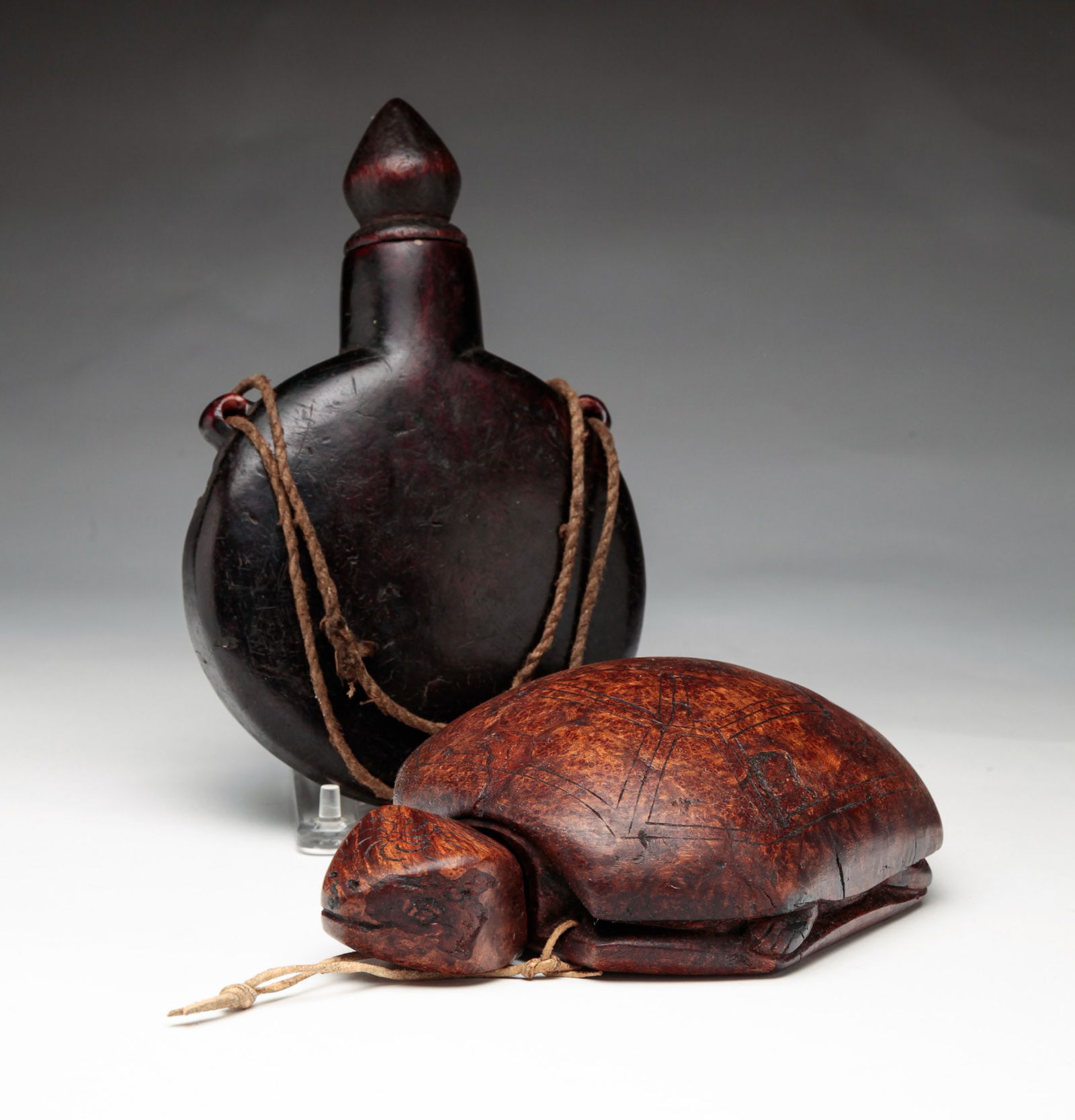 TWO BURL GUNPOWDER FLASKS.: Chinese, late 19th Century. Plain with dark surface and patched repair, 8"h. And turtle shaped, 8"h.