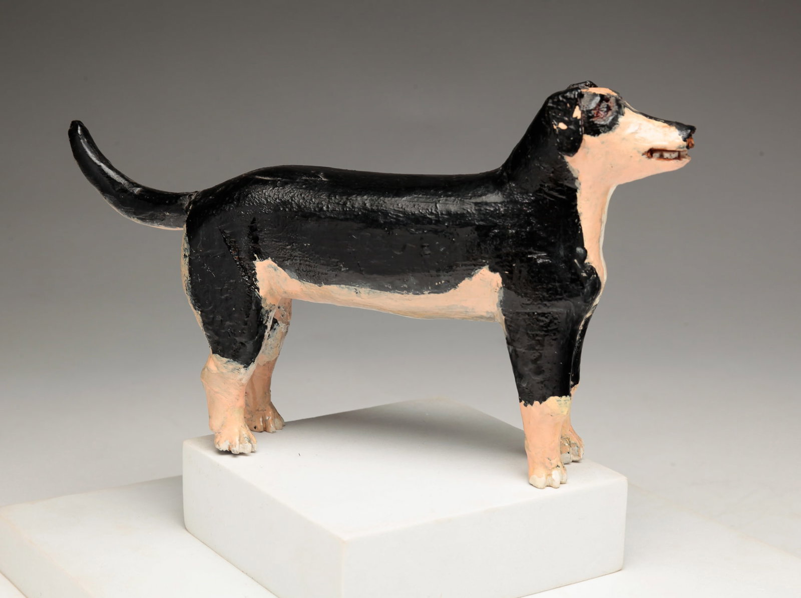 PRIMITIVE FOLD WOOD CARVED DOG.: American (Michigan). Original paint with tin ears. 8"l. 4.5"h.