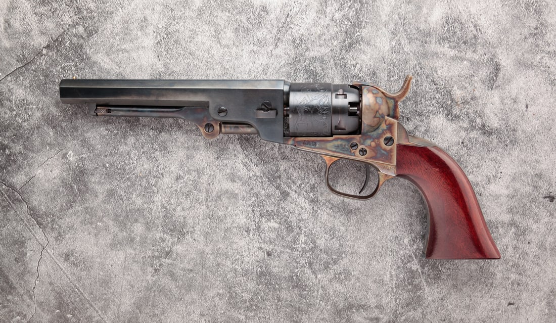 COLT BP SERIES 1862 POCKET NAVY .36 REVOLVER.: Colt BP Series 1862 pocket navy .36 caliber single action revolver. Smooth wood grips with blued frame, barrel and engraved fluted cylinder. 5-1/2" barrel length, 10-1/2" overall. Serial number 50214.