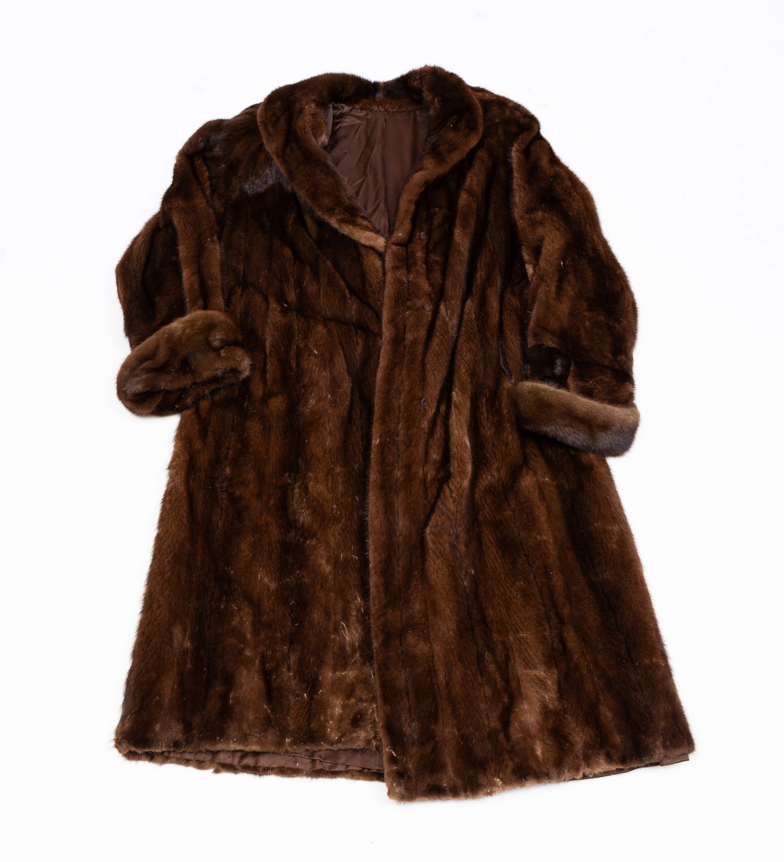 FULL-LENGTH FUR COAT.: Some damage and wear to the inside lining. 53" from collar to bottom. From the collection of the late Audrey Caspari (New Jersey).