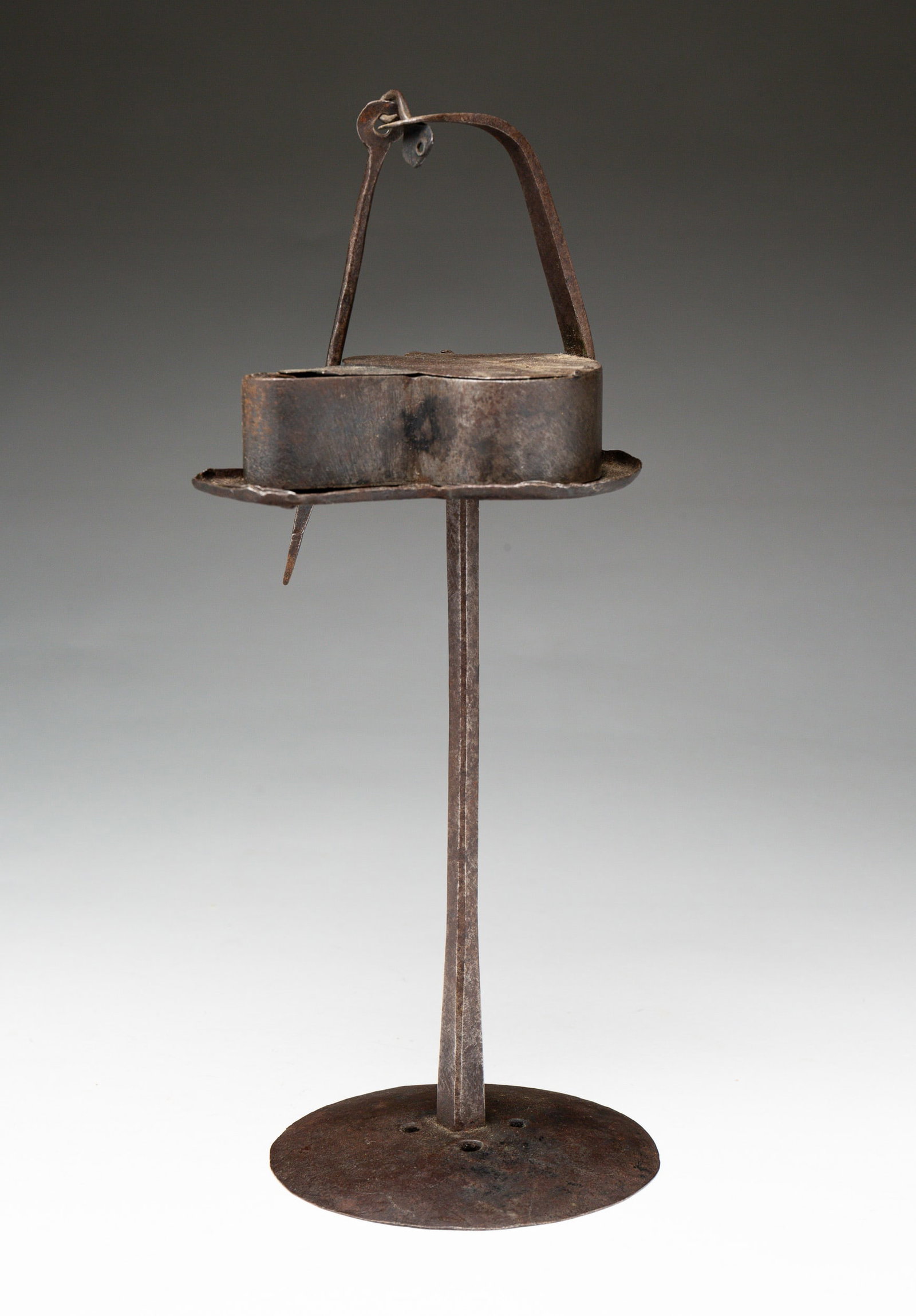 BETTY LAMP AND TIDY.: American, mid 19th Century. Forged iron. Tidy with shaped top, tapered square stem and round base, and single burner lamp with hook hanger. 12"h.