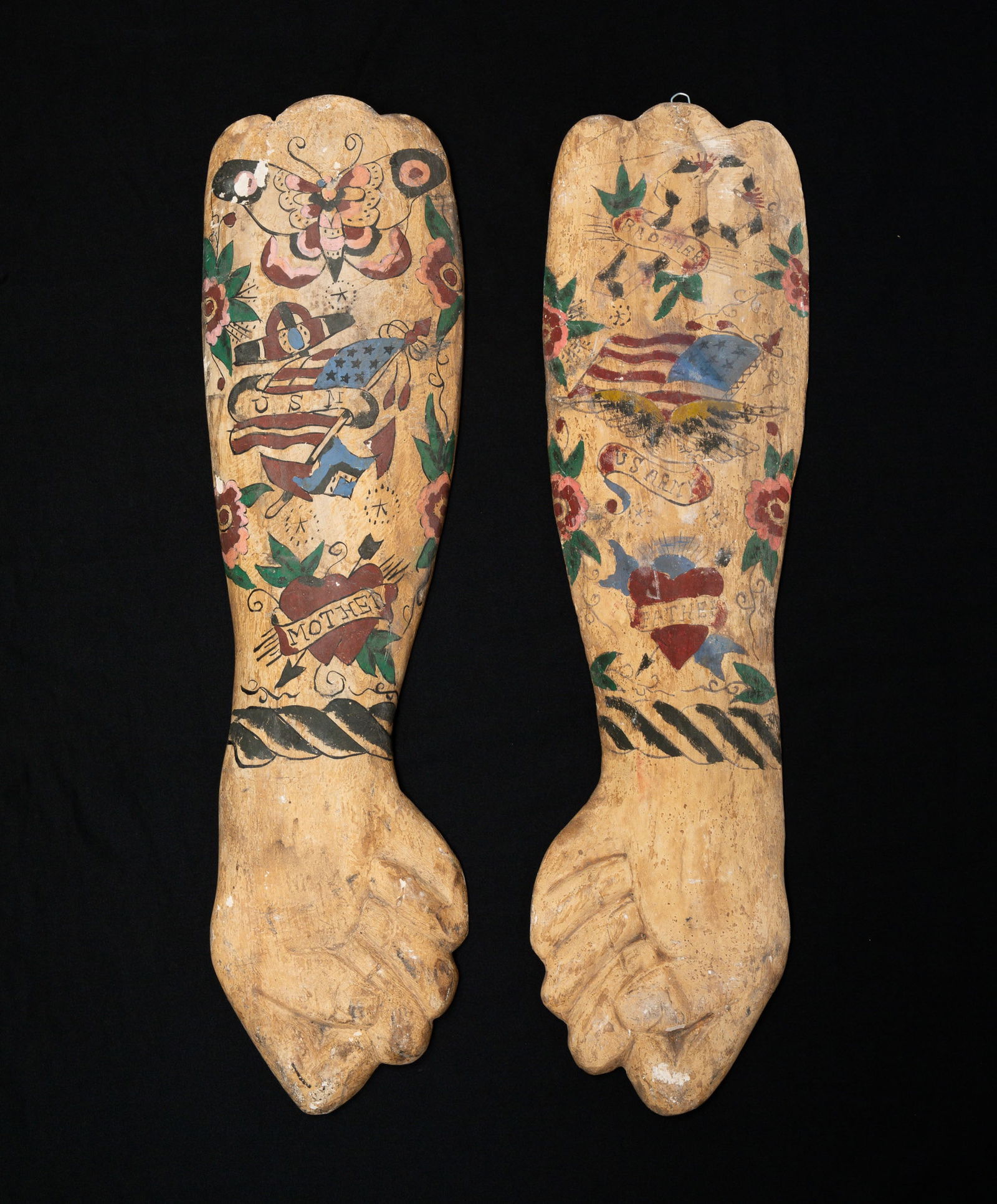 TATTOO PARLOR TRADE SHOP SIGNS.: (Likely) Asia, 20th - 21st Century. Polychrome decorated carved wood. Pair of figural forearm with hand folk art tattoo trade signs. 30.5"l. From the collection of the late Audrey Caspari (New Jersey)