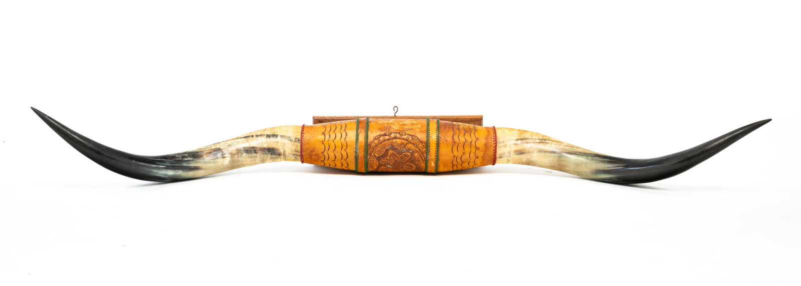 STEER HORNS.: Tooled leather center, on base for mounting. 5.5"h. 76"l. 14"d.
