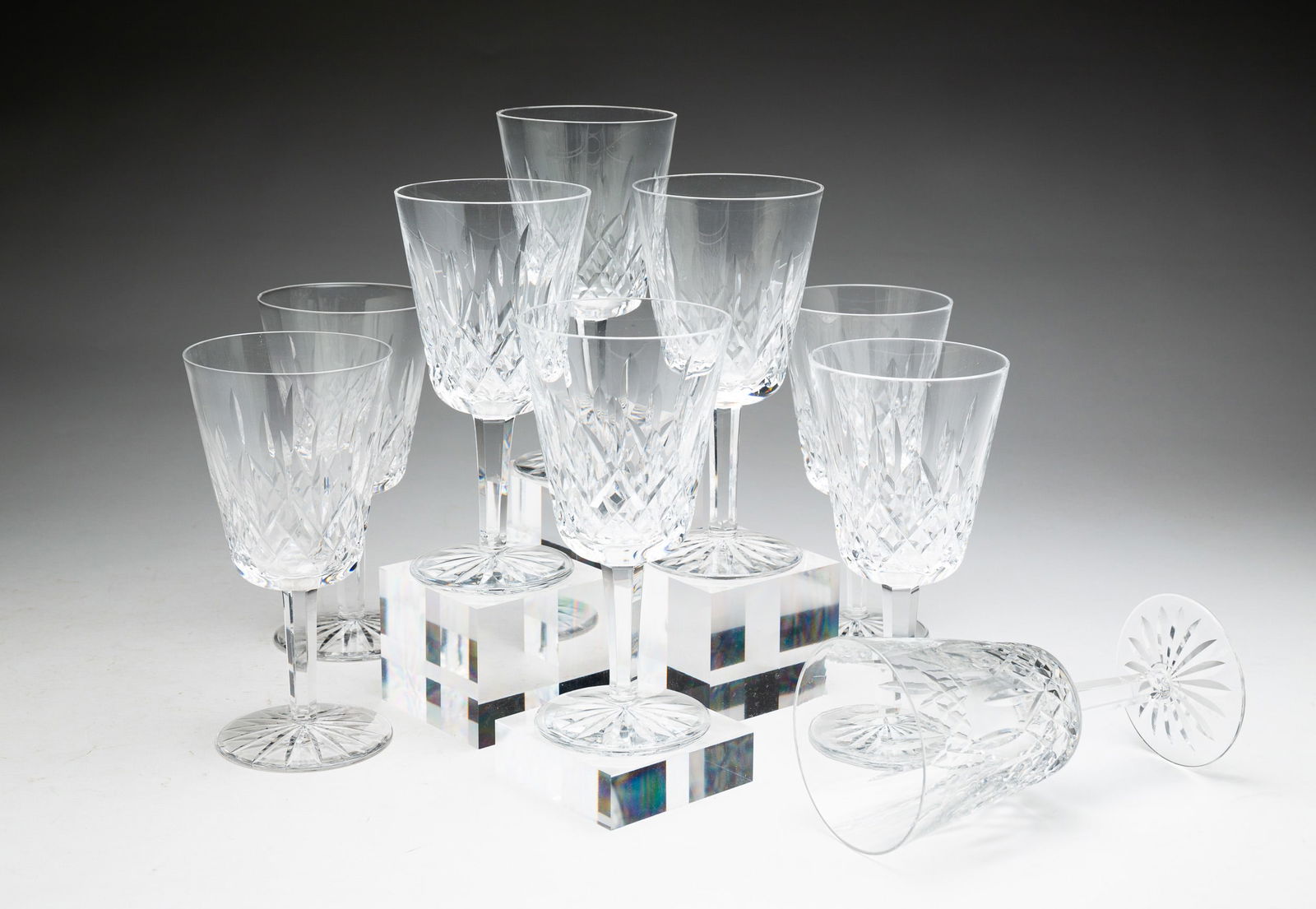 NINE WATERFORD "LISMORE" WATER GOBLETS.: Ireland, late 20th Century. Lead crystal. Nicely cut and signed on foot. One rim chip. 7"h.