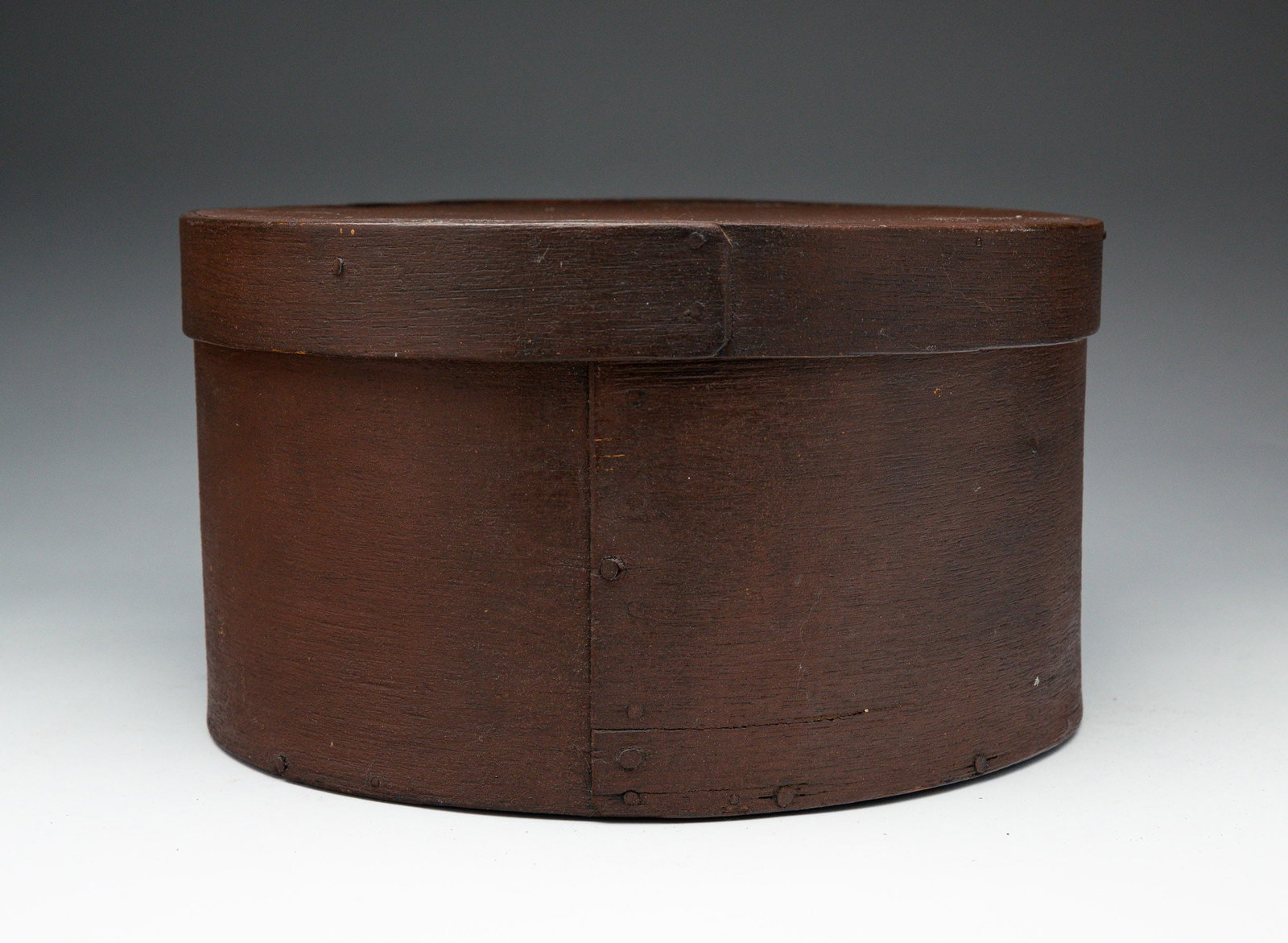 PAINTED PANTRY BOX.: American, 19th Century. Bentwood in a chestnut brown paint. 10"dia. 6"h.