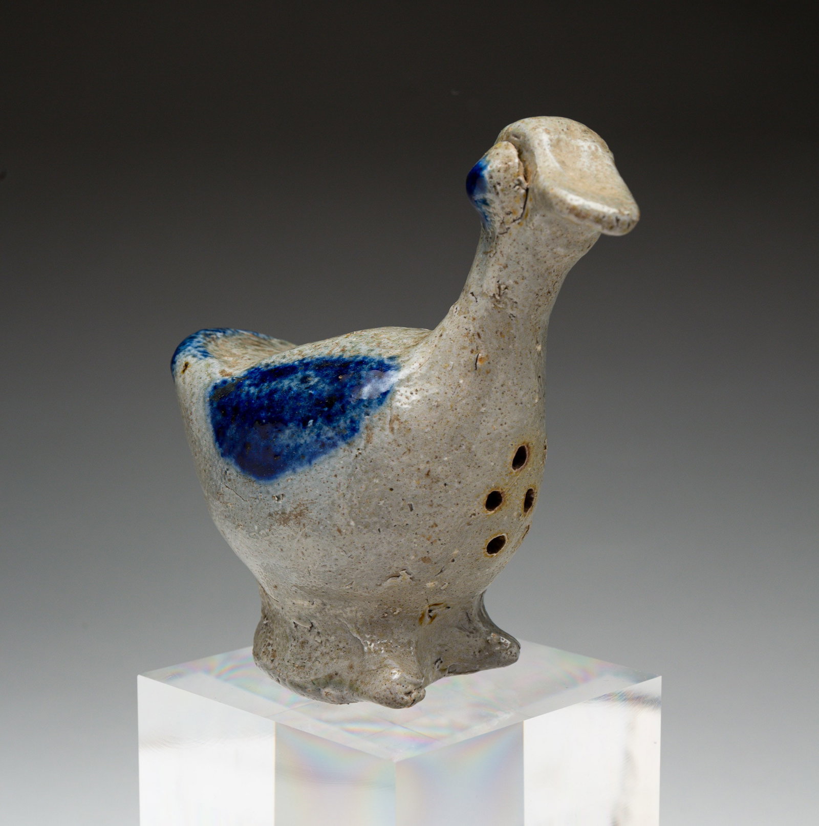 SCARCE FOLKSY FIGURAL STONEWARE DUCK SANDER OR SUGAR SHAKER.: American (probably Pennsylvania), late 19th Century. Cobalt-decorated hand-formed duck with pinched beak and tail, applied eyes, and applied base with pinched feet. Approx. 4.75"h. From The First Inst