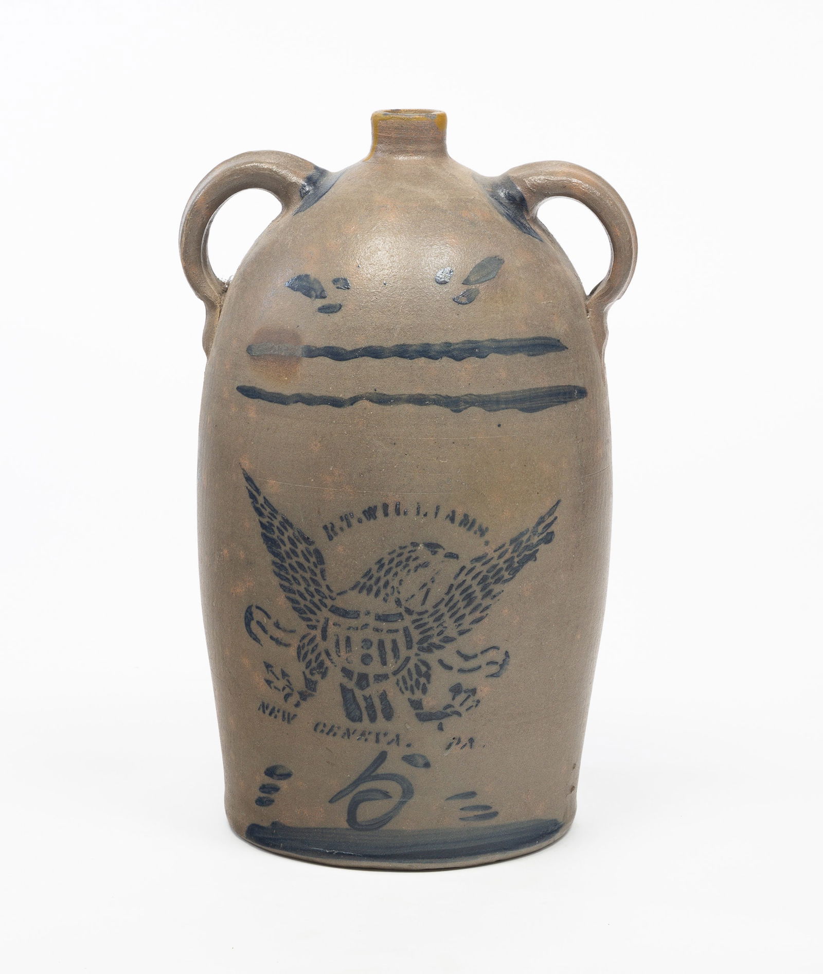 R.T. (ROBERT T.) WILLIAMS (NEW GENEVA, PA) DOUBLE-HANDLED EAGLE FIVE-GALLON STONEWARE JUG.: American (Southwestern Pennsylvania), 19th Century. Cobalt decoration with stenciled eagle with shield, maker's name and location; and freehand "5" with dabs and stripes at bottom and top. Wide applie