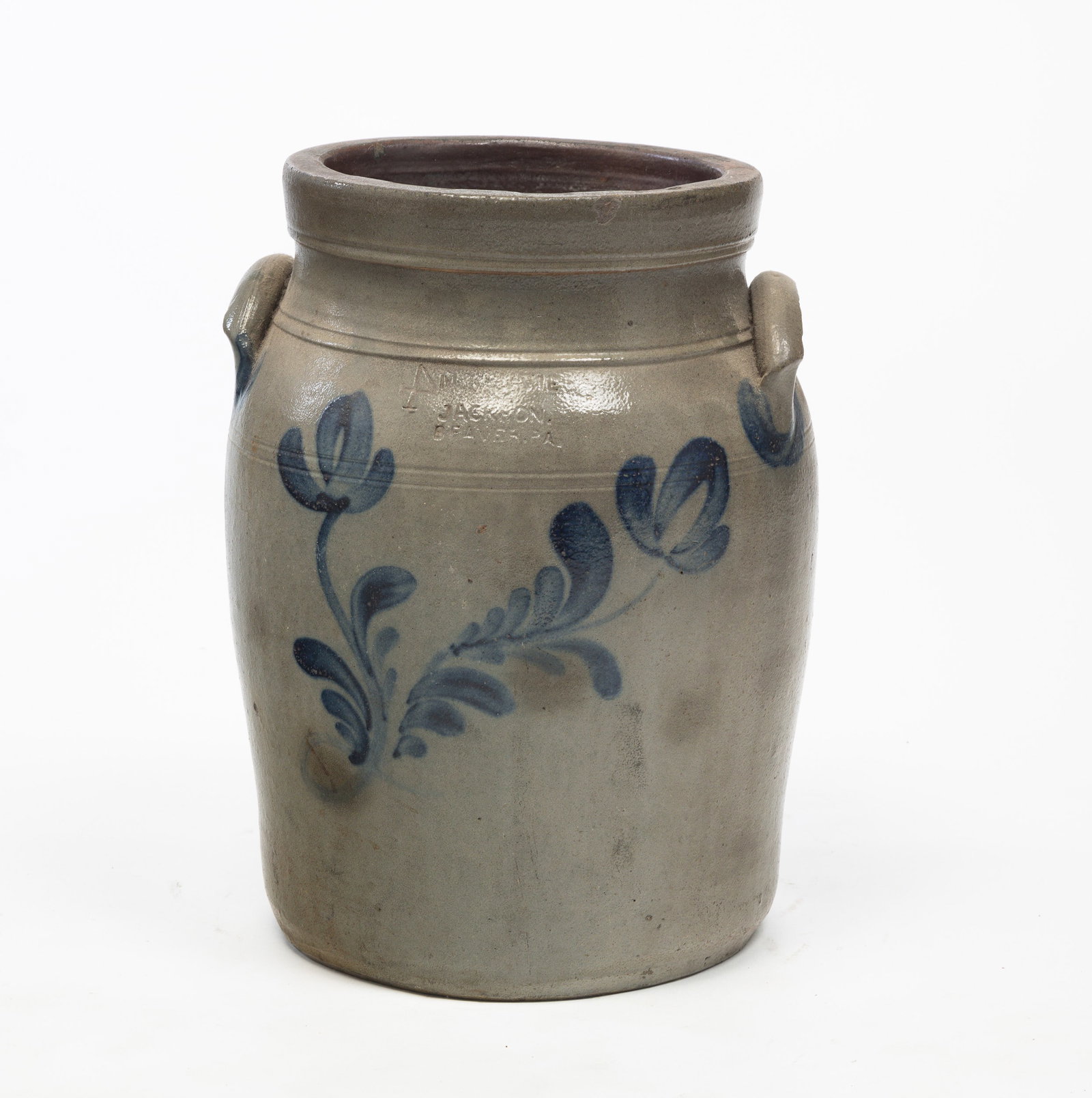A MCKENZIE & JACKSON (BEAVER, PA) STONEWARE JAR WITH FREEHAND DECORATION.: American, 19th Century. Freehand cobalt flowers on front with impressed mark at top, lug handles. 13.75"h. From The First Installment of The Beth & Earl Trimble Salt Glazed Stoneware Collection.