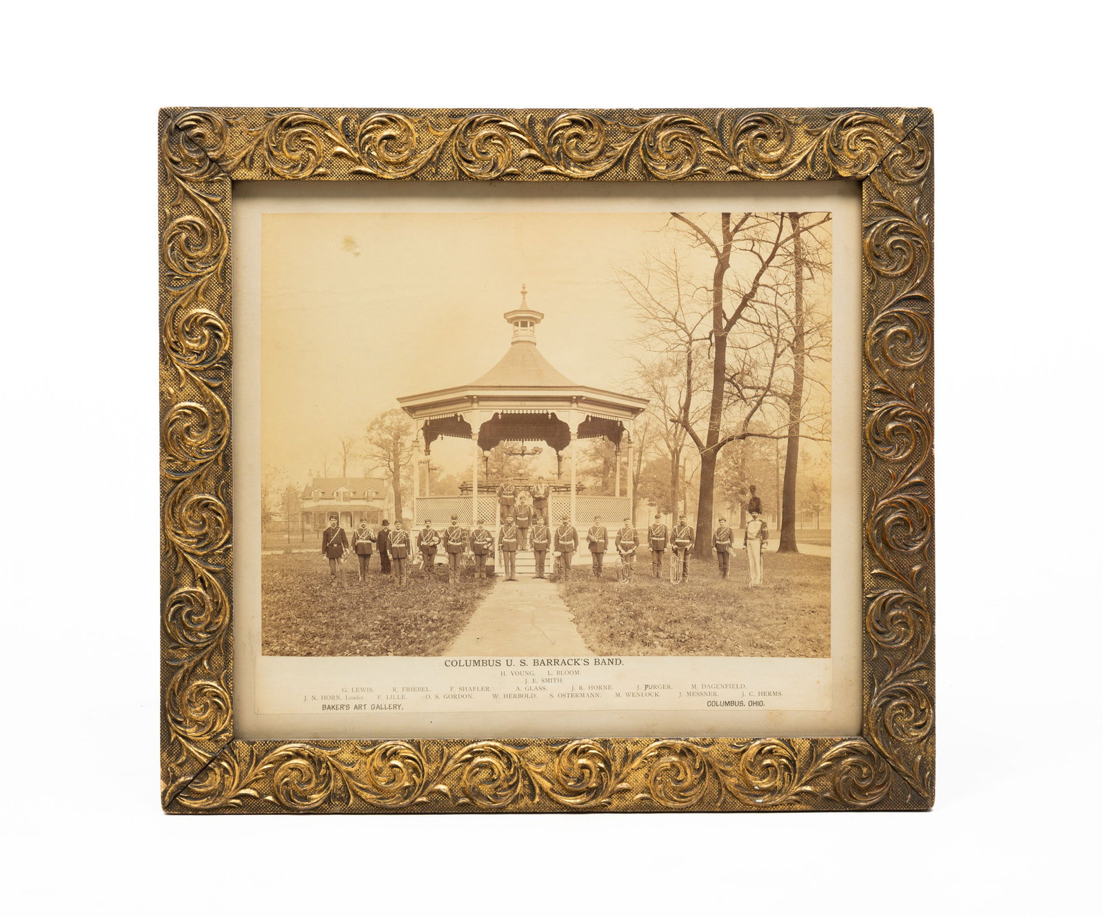 POSED IMAGE OF COLUMBUS U.S. BARRACKS BAND.: Fourth quarter 19th Century. Albumen Print. The uniformed band posed on and in front of the ornate bandstand in the Barracks Yard. Taken by Balcers Art Gallery, Columbus. Bottom margin lists the membe