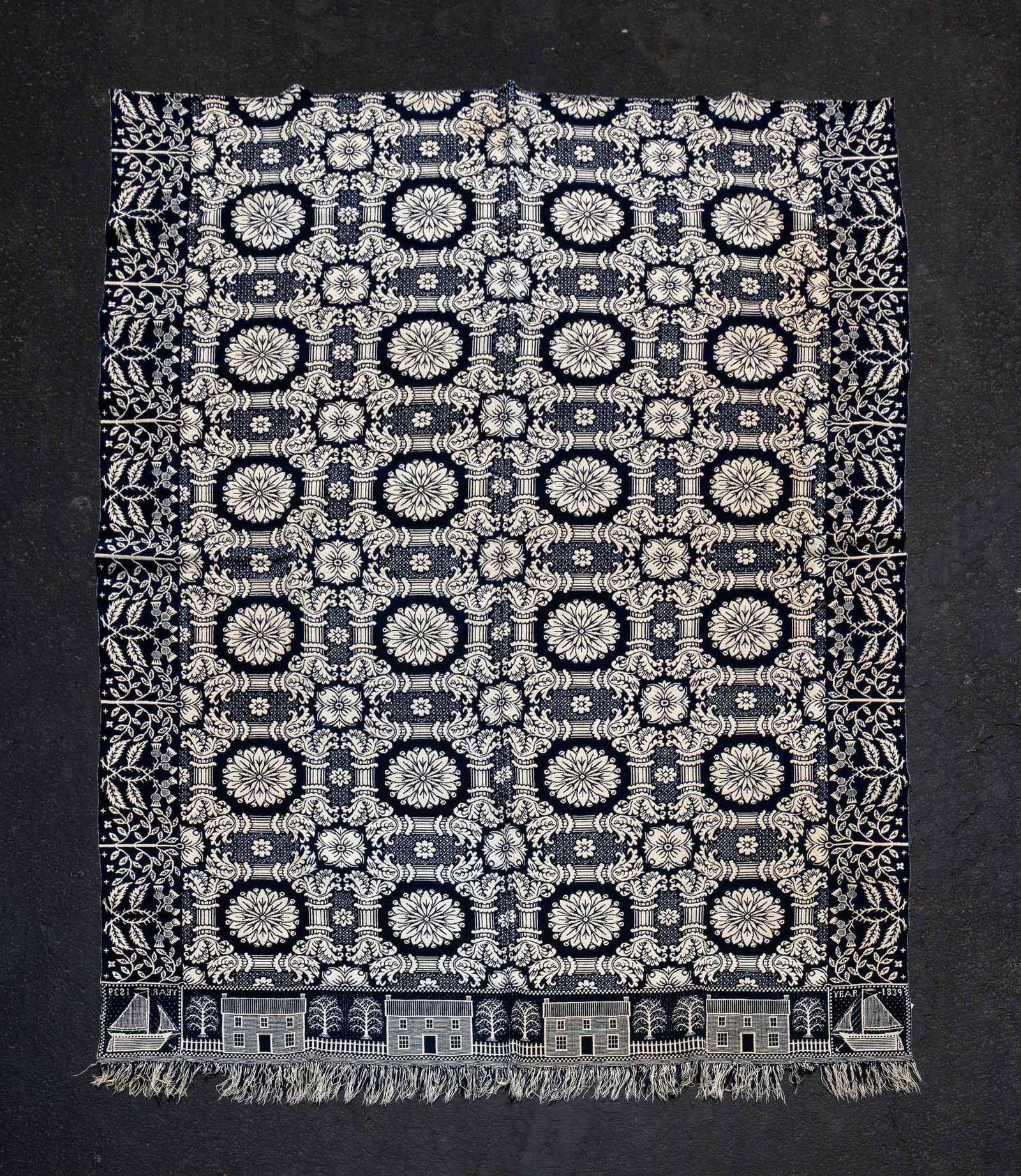 INDIANA DOUBLEWEAVE COVERLET BY GILMORE: American, William or Joseph Gilmour (Union County, Indiana), dated 1839. Wool in indigo and white. Corner blocks with sailboat and "Year 1839". Log cabin and fence border, center field with floral med