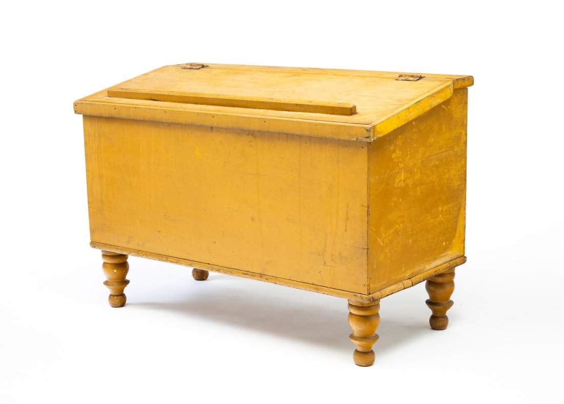 OHIO EMPIRE PAINTED GRAIN BIN.: American, second quarter 19th Century. Pine. Slanted hinged lid, turned legs and two well interior. Old mustard yellow paint over original red. Wear and legs are loose. 26.5"h. 39.25"w. 19.5"d.