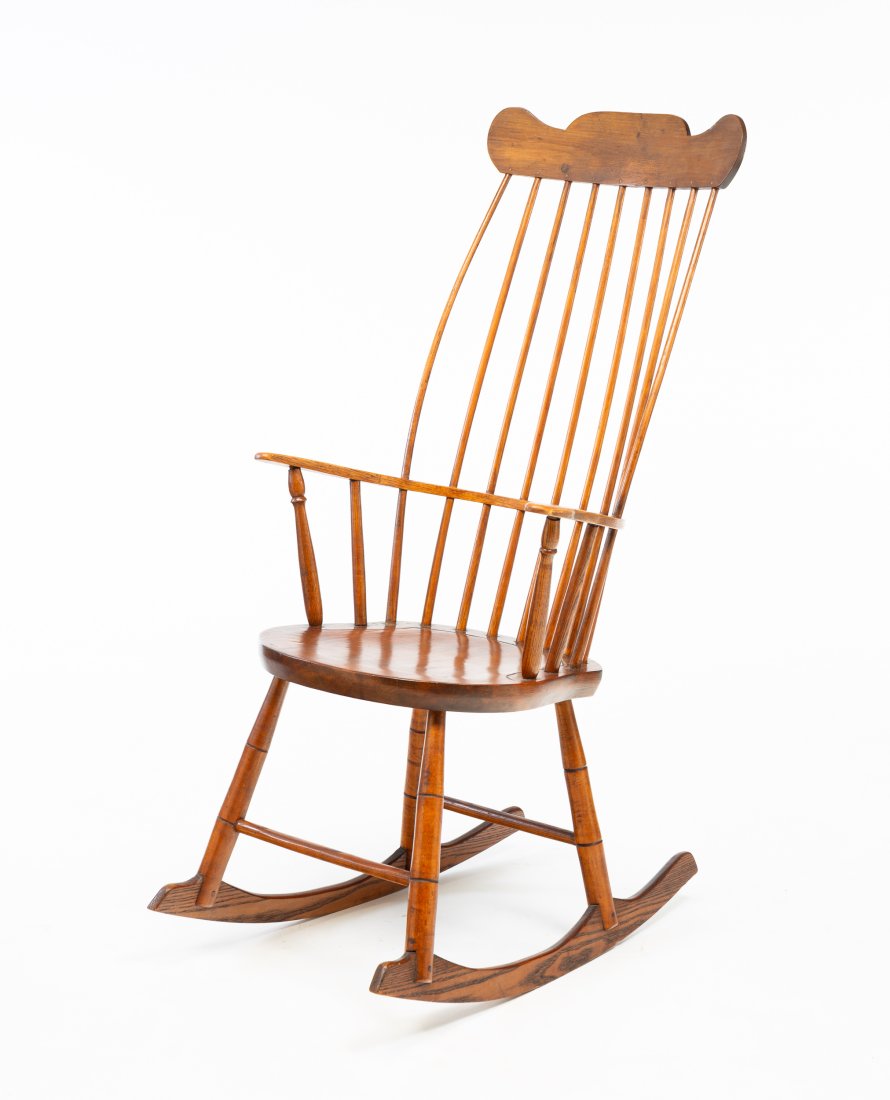 COMB BACK WINDSOR ROCKING CHAIR.: American (probably Ohio), circa 1800. Mixed woods. Spindle-back turned stiles and bamboo turned legs. Refinished and crest may be an old replacement. 17.25"h seat. 43.5"h. Ex Garth Oberlander and Caro