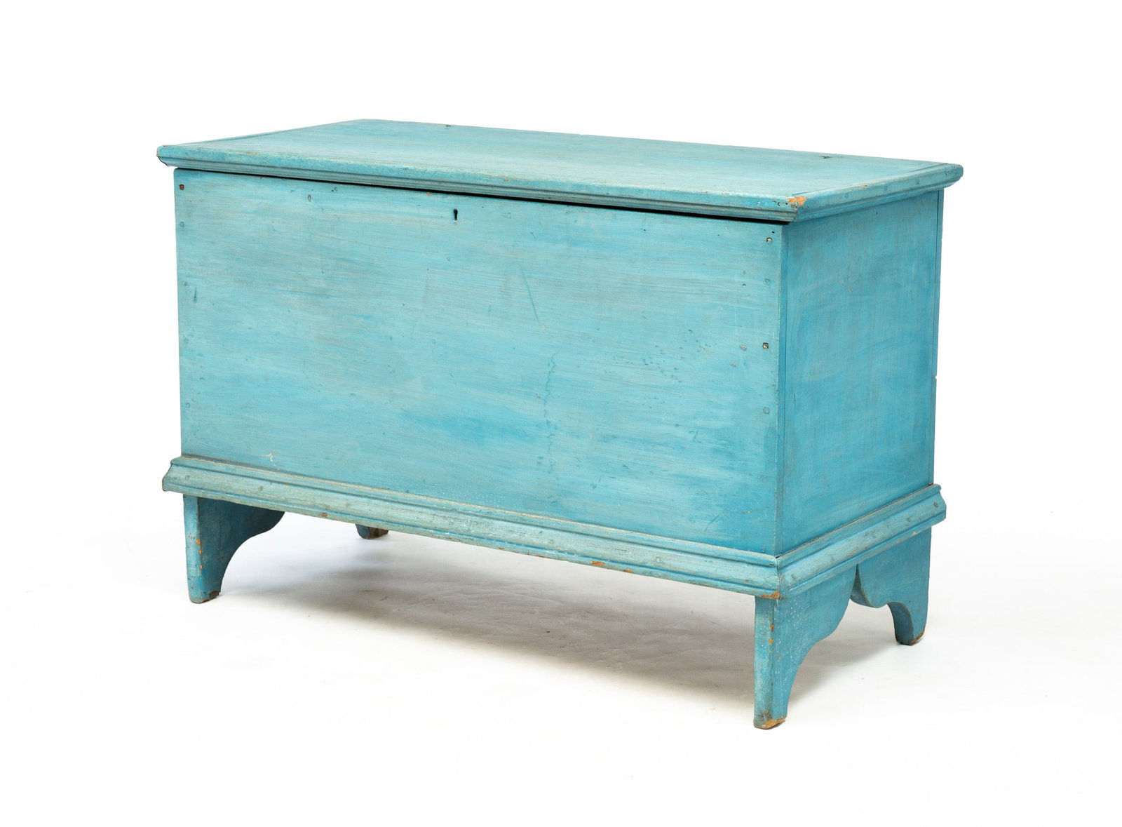 EARLY PAINTED BLANKET CHEST.: American (Ohio). Poplar in original blue painted finish with overhanging lid with thumb molded edge, interior with lidded till, applied molding around base with cut-out boot-jack ends. 24.25"h. 36"w. 