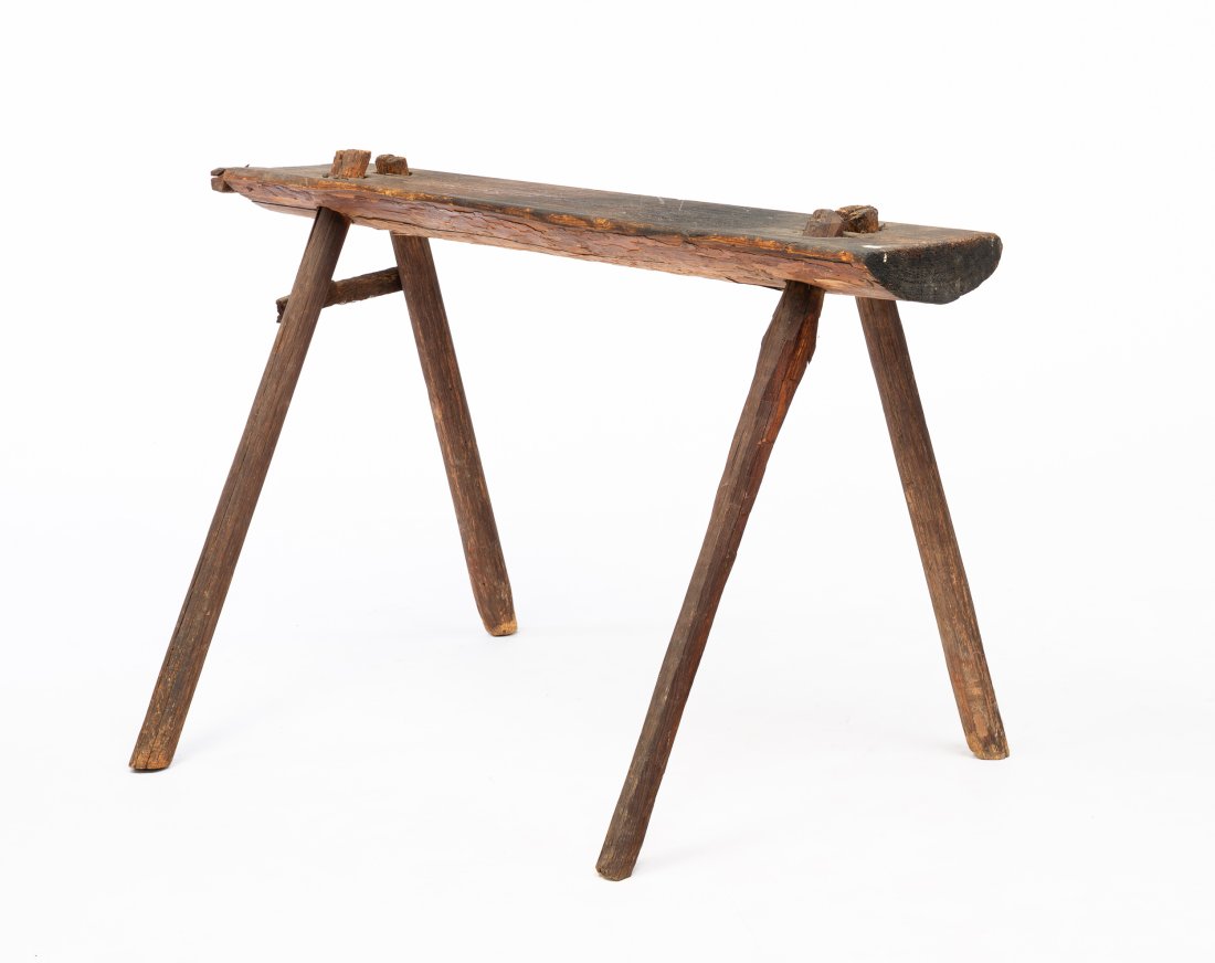 PRIMITIVE WEAVER BENCH FROM THE GORDON FAMILY.: American (Barlow Township, Washington County, Ohio). Slab of pine log, retaining bark, seat and oak legs. Some wear and loose legs. 28"h. 40.5"w. 8.75''d.