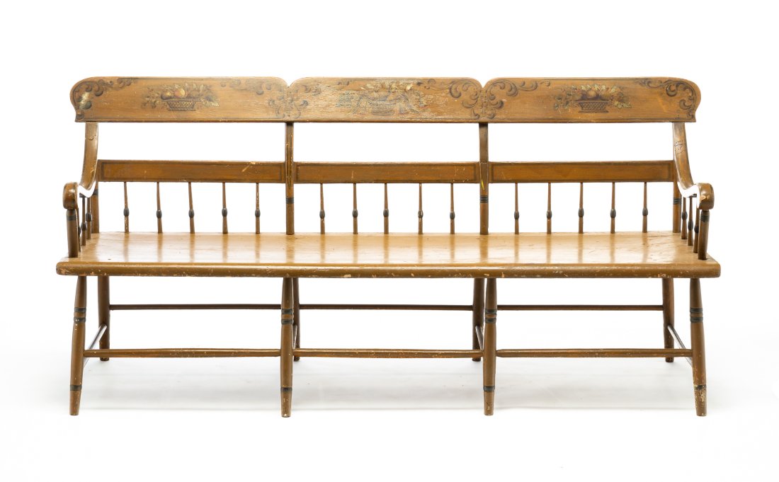 STENCIL DECORATED SETTLE BENCH.: American, second quarter 19th Century. Mixed woods. Shaped crest, half spindle back, deep seat, scrolled arms and simple turnings. Original green paint and stenciled flourishes and baskets of fruit. S