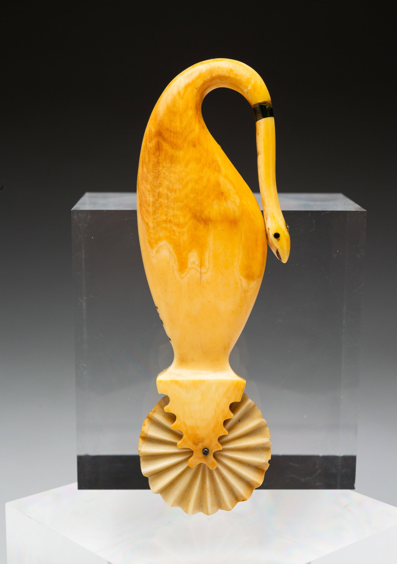 SCHRIMSHAW PIE CRIMPER.: American, possibly Nantucket, 19th Century. Scrimshaw and baleen. Whale shape with snake handle. 23.8.1 on side. Repairs