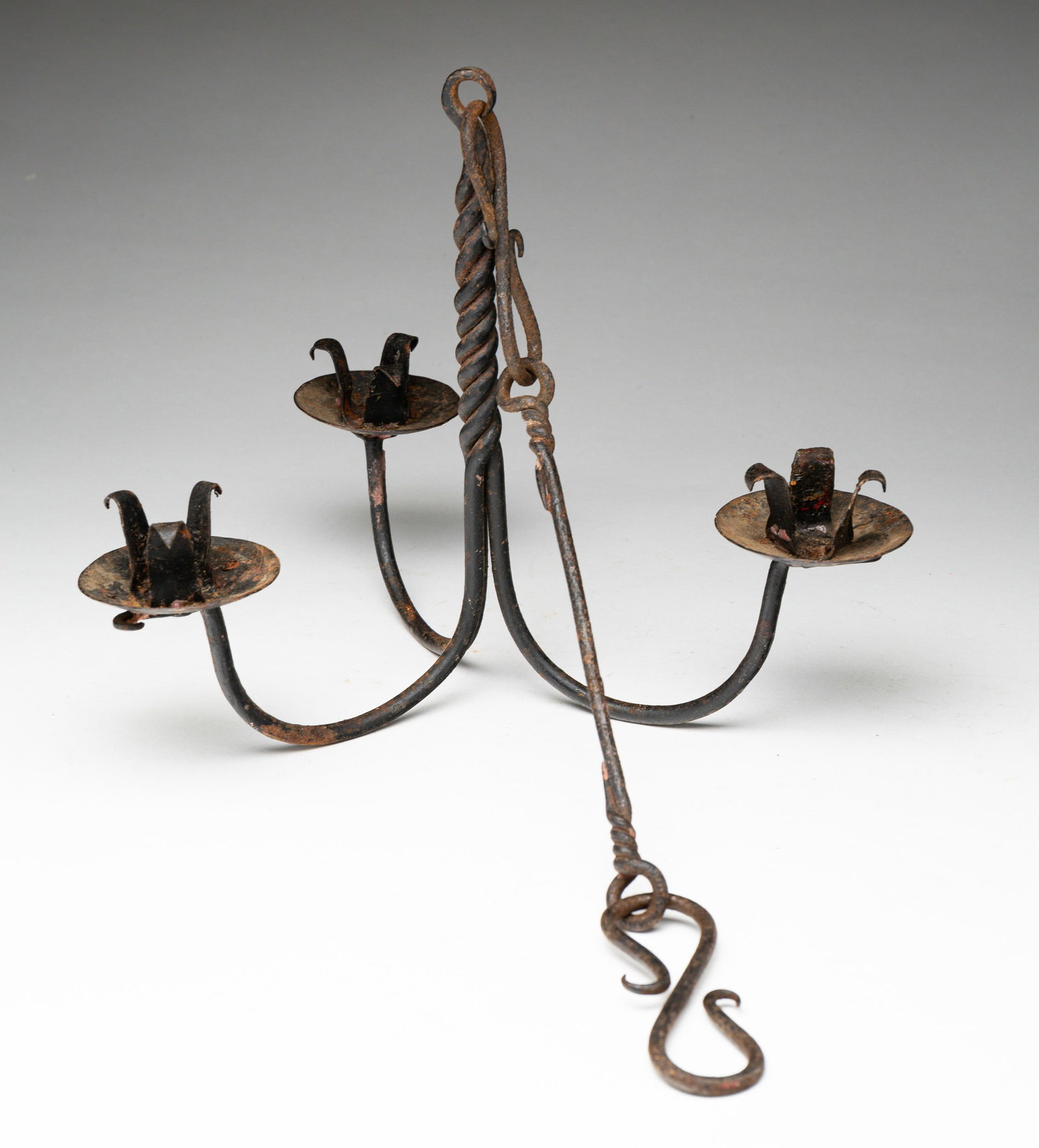 FORGED IRON HANGING CHANDELIER.: American or European, late 18th - early 19th Century. Three-arm. Fully hung height, 20.5"h. Candle arms, 8"h. 10"w. From the collection of the late Audrey Caspari (New Jersey).