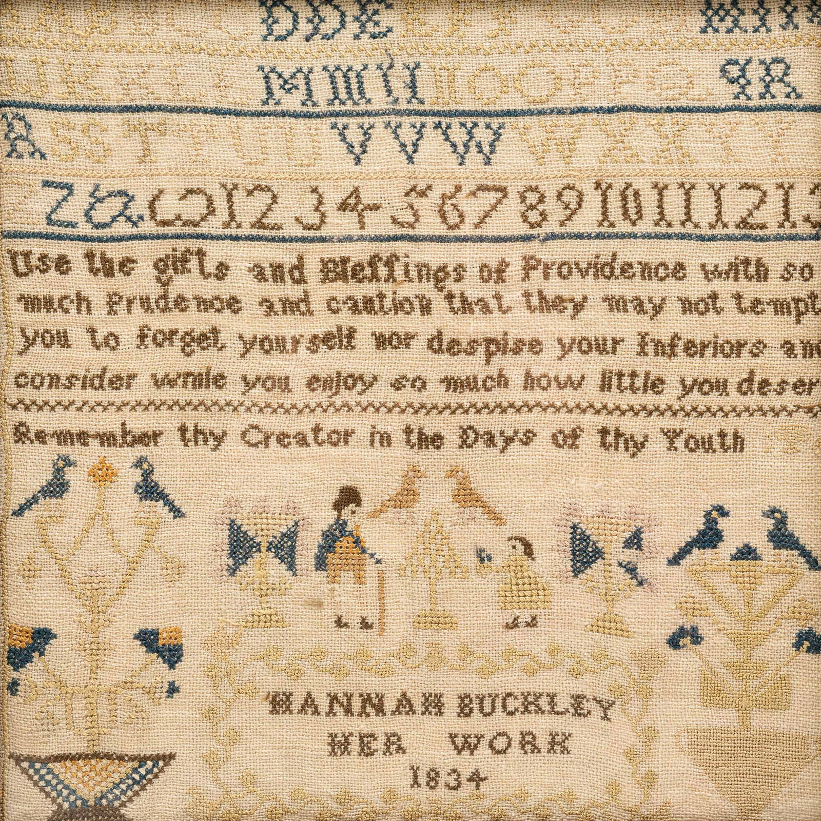 SAMPLER BY HANNAH BUCKLEY.: England, second quarter 19th Century. Linen. Alphabet, numerals, urns of flowers, birds, people and verse. Some fading. Contemporary frame. 14.25"h. 16.25"w. From the collection of the late Audrey Cas