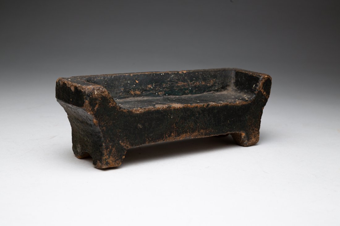 CARVED STONE MINIATURE SOFA.: American, mid 19th Century. Empire style sofa with worn black paint. Some edge chips. 3"h. 8.25"w. 2.25''d.