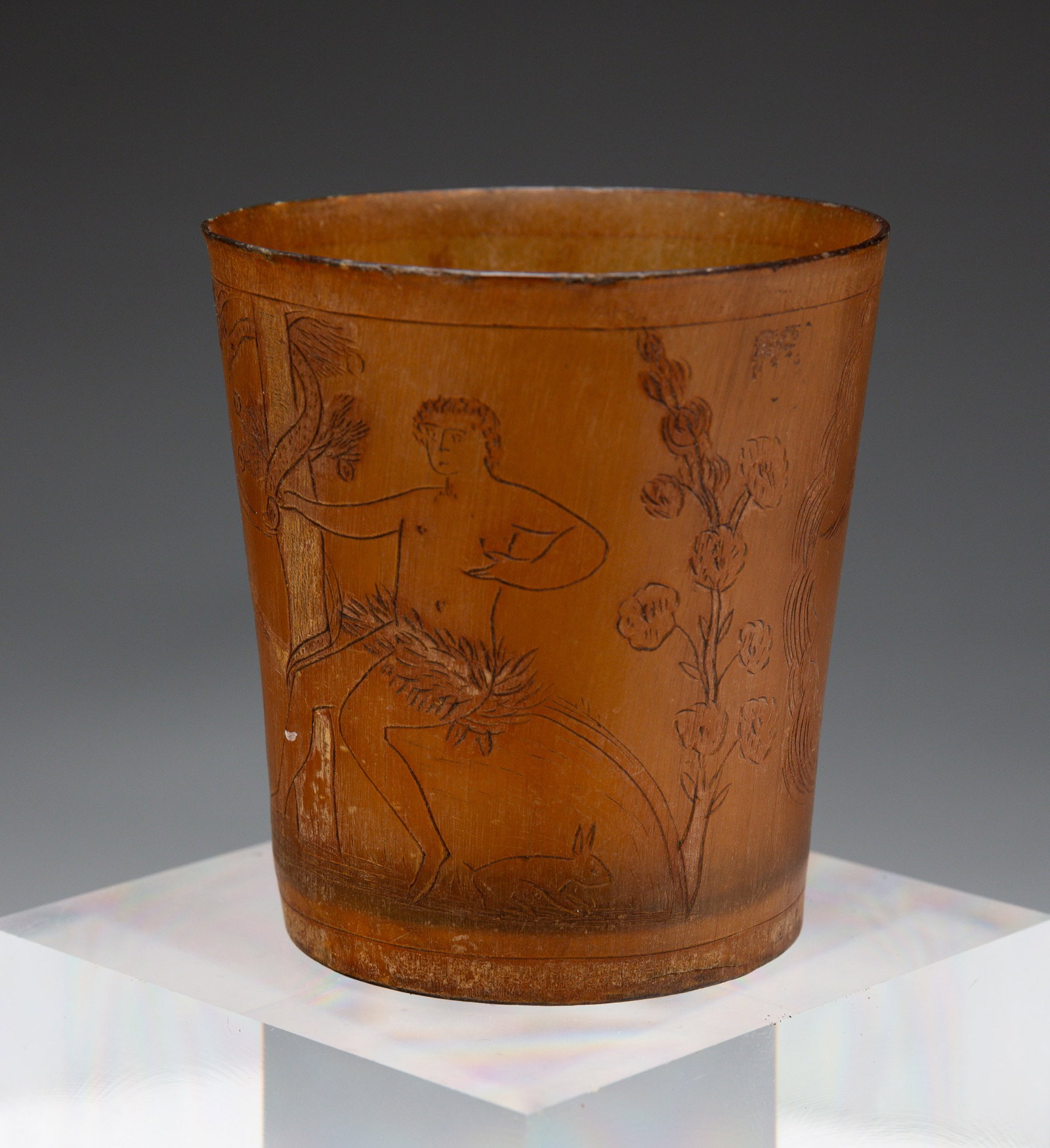 HORN CUP.: Incised Adam and Eve garden scene with serpent around tree; primitive lion, two angels,2.75"h., 2.5"dia.