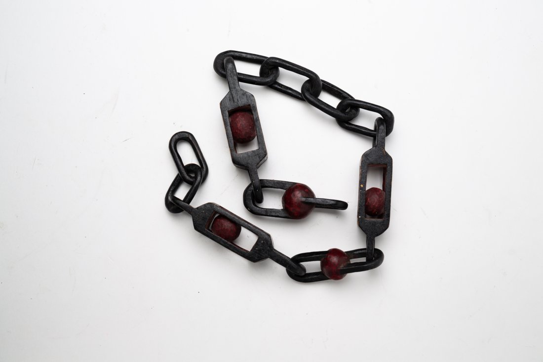 CARVED AND PAINTED WHIMSY.: American, first half 20th Century. Pine. Carved from one piece of wood, a chain and cages with spheres. Original black and red paint. 21"l.