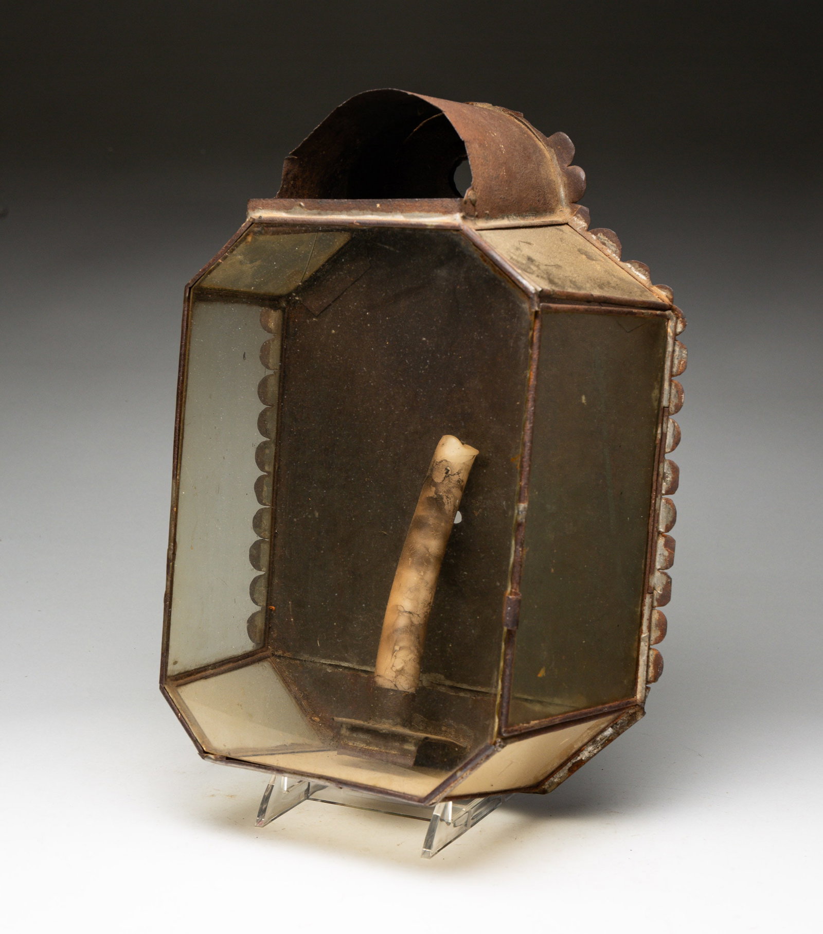 UNUSUAL TIN CANDLE WALL SCONCE.: European, 19th Century. Tin, glass. Scalloped edge with seven glass panels plus a glass front. 13"h. 8.5"l. From the collection of the late Audrey Caspari (New Jersey).