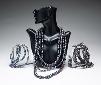 FOUR STRANDS CULTURED TAHITIAN PEARLS.