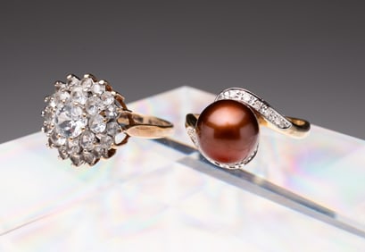 TWO LADIES GOLD AND GEMSTONE RINGS.