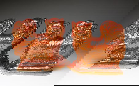 A MIRRORED PAIR OF SEWER TILE SPANIELS.