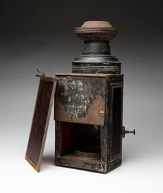 TIN LANTERN WITH RED LENS.