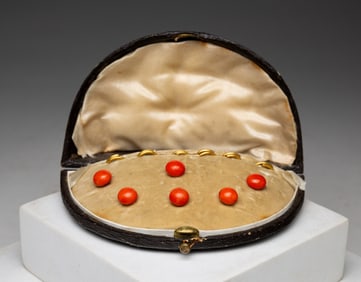 BOXED CASE OF CORAL BUTTONS.