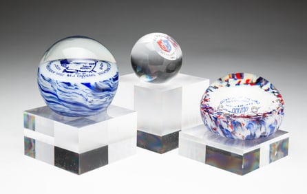 THREE COMMEMORATIVE PAPERWEIGHTS.