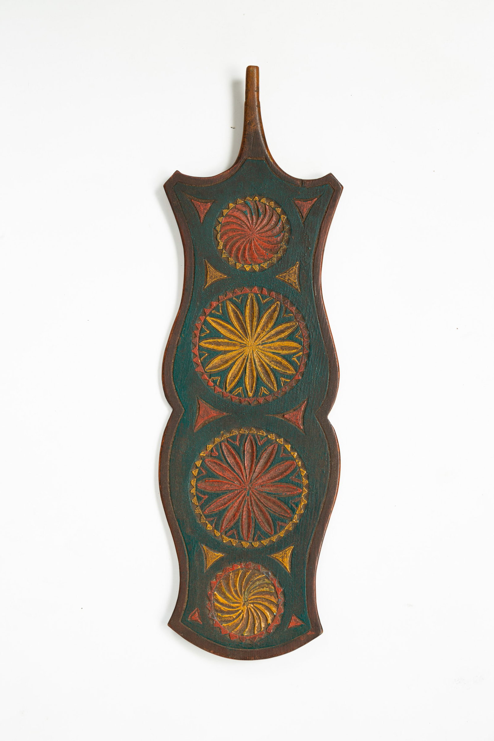 CARVED AND PAINTED DISTAFF.: Scandinavian, second half 19th century. Polychrome paint shaped sides with incised border pinwheels and mariner compass green ground, 18"l.