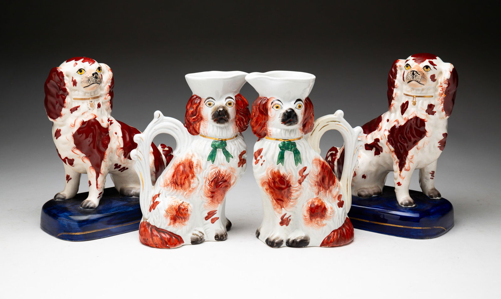 TWO PAIRS OF STAFFORDSHIRE SPANIELS. (1 of 4)