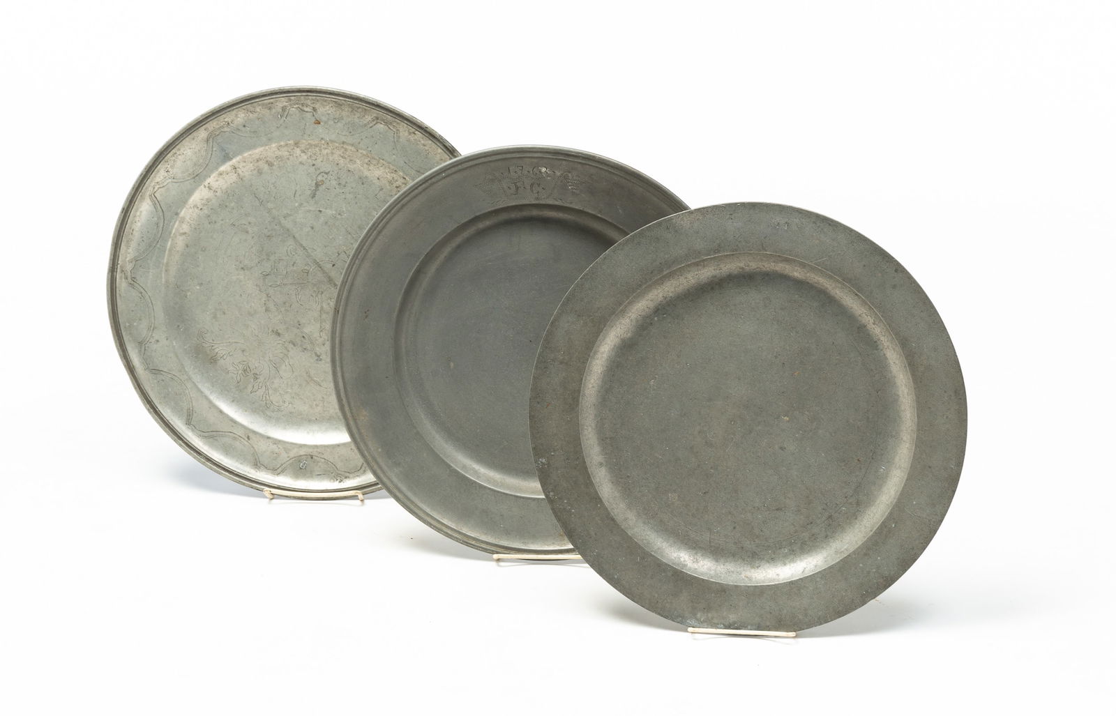 THREE PEWTER CHARGERS. (1 of 8)