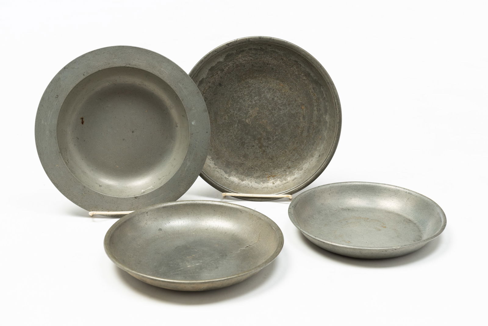 FOUR PEWTER PLATES. (1 of 5)
