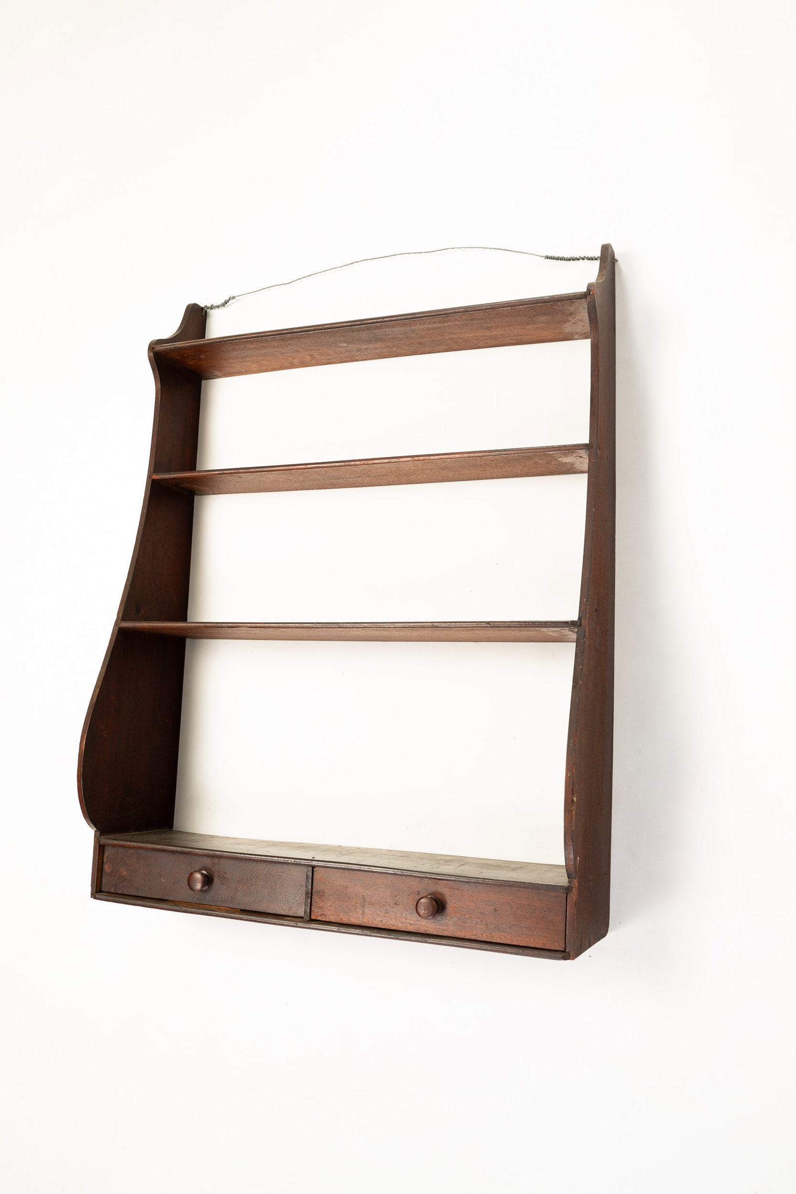 SET OF WHALE END HANGING SHELVES.: American (New England), mid 19th Century. Walnut with pine secondary. Four shelves and two lower drawers. Old dry finish has some wear. 34"h. 25.25"w. 8.25"d.