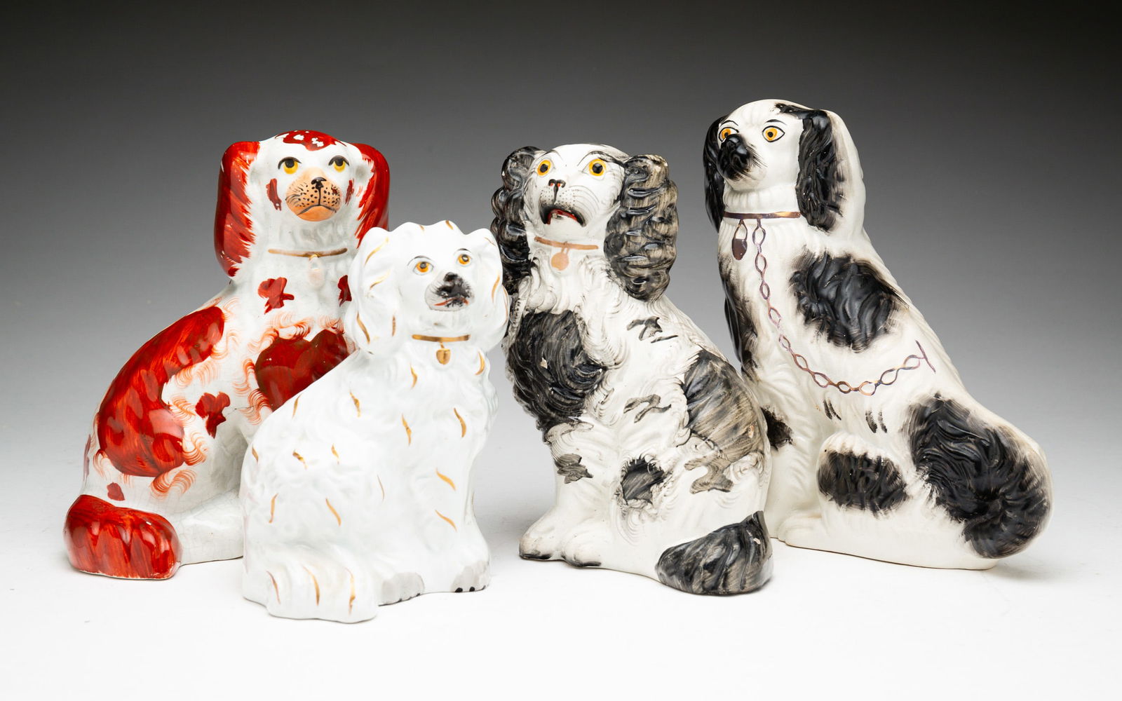 FOUR SEATED STAFFORDSHIRE SPANIELS. (1 of 7)