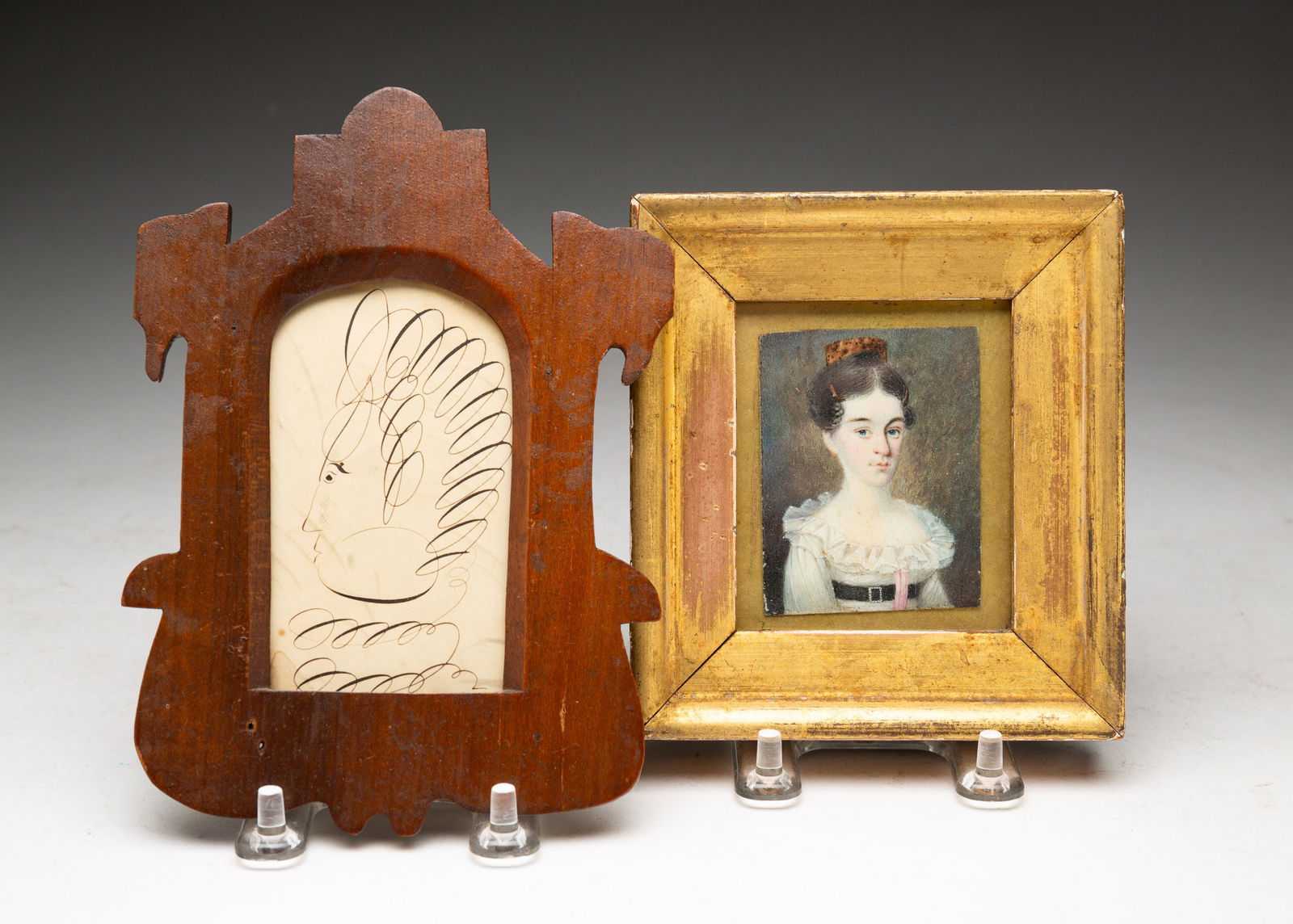 TWO MINIATURE PORTRAITS.: American, mid 19th Century. A young girl with tortoise shell comb, with chess with lace collar and pink sash in a gold leaf frame. 5"h. 4.5"w. And a Spencerian profile of a man in folksy walnut frame.