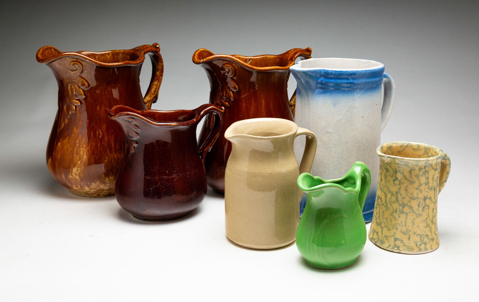 SEVEN CERAMIC PITCHERS. (1 of 4)