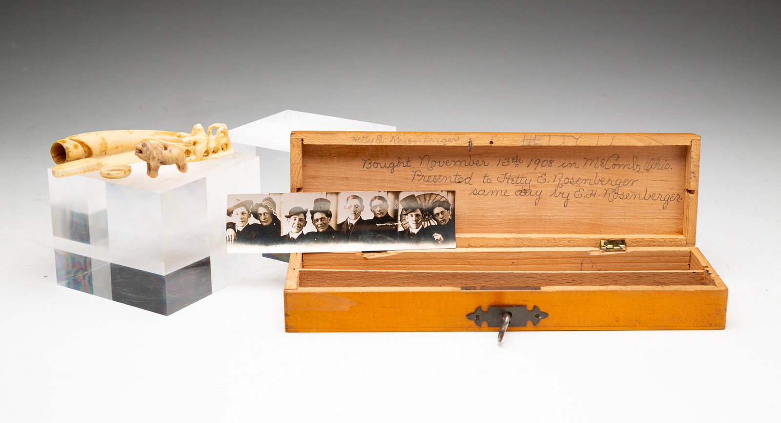 BOX OF MINIATURE CARVINGS.: American (Ohio), dated 1908. Narrow and flat pine pencil box with five carved whimseys in bone or ivory: miniature handled machete, 2.5"l.; round carved ring, 0.5"dia.; Inuit-type miniature carving of