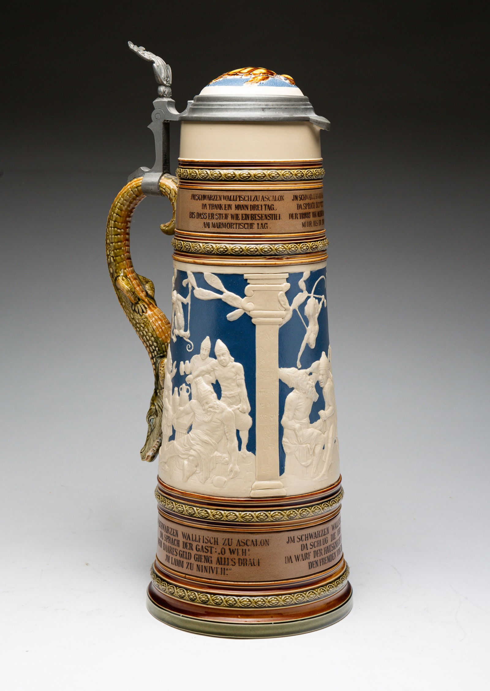METTLACH "EVENTS AT THE WHALE AT ASCALON'' STEIN.: German, 20th Century. No. 2194, high relief with alligator handle. 18"h.
