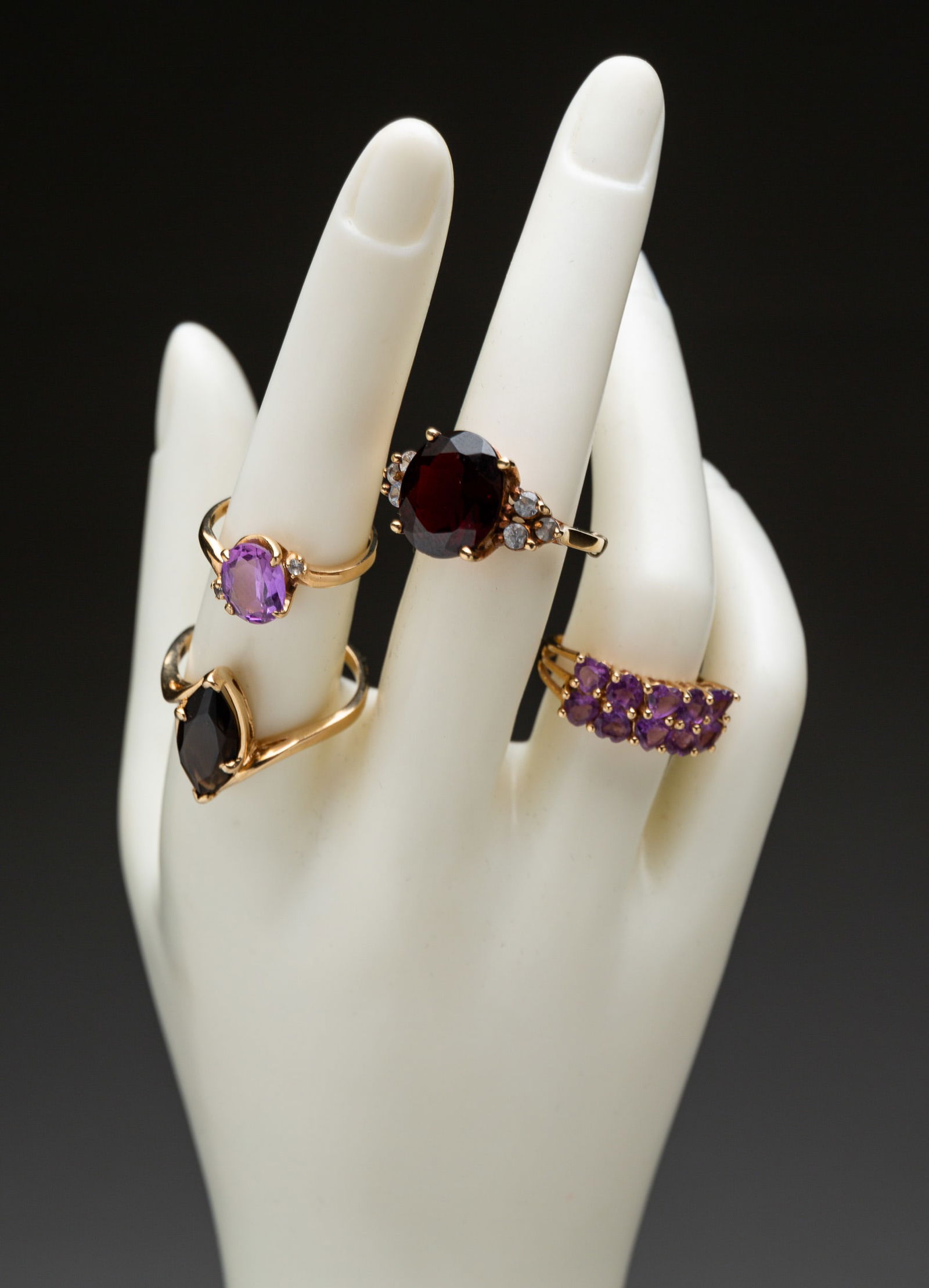 FOUR 10 KARAT GOLD AND GEMSTONE RINGS. (1 of 3)