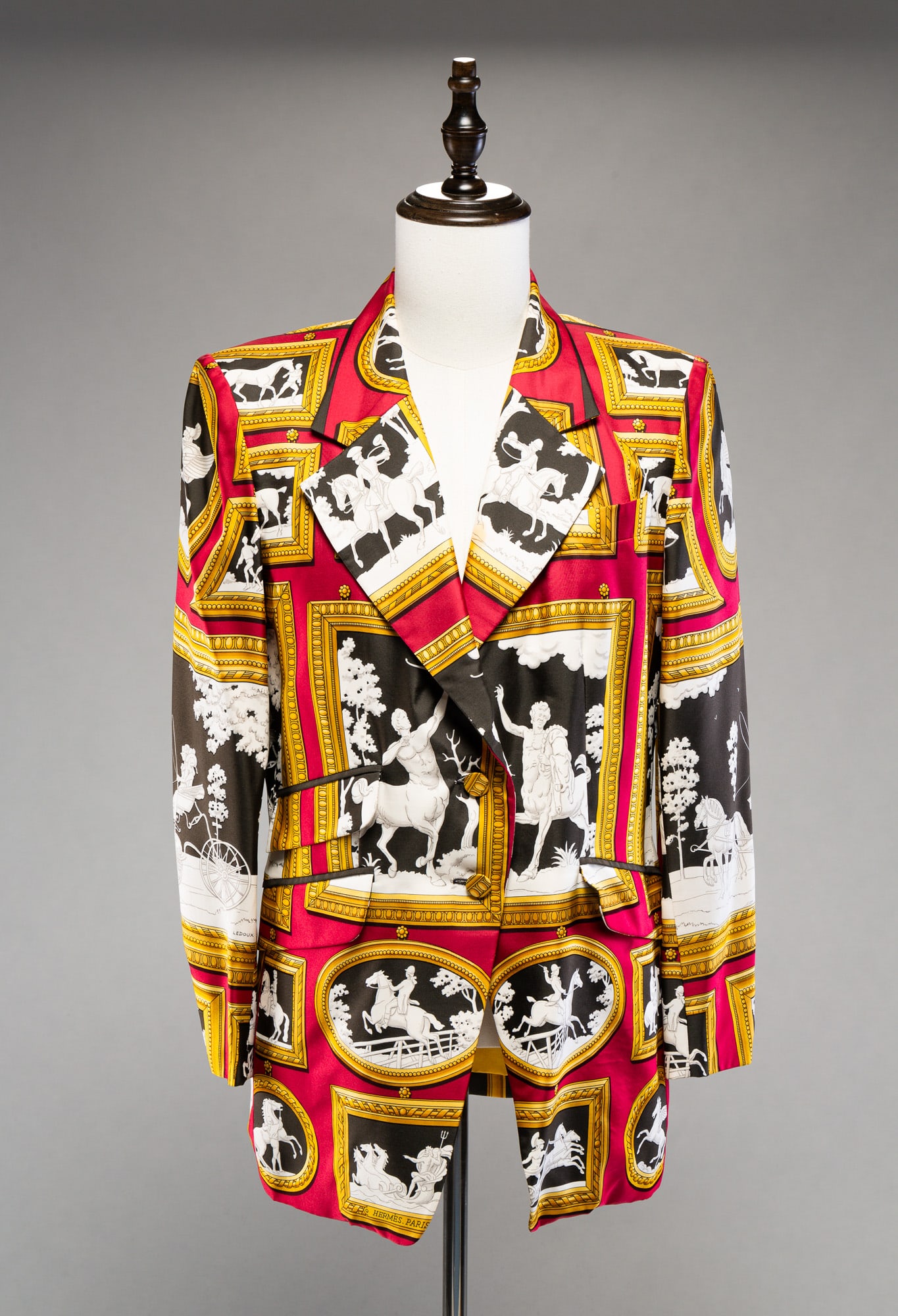 HERMES WOMEN'S EQUESTRIAN BLAZER.: French. Silk. Size 44. Magenta ground with framed relief sculptures of horses and riders.